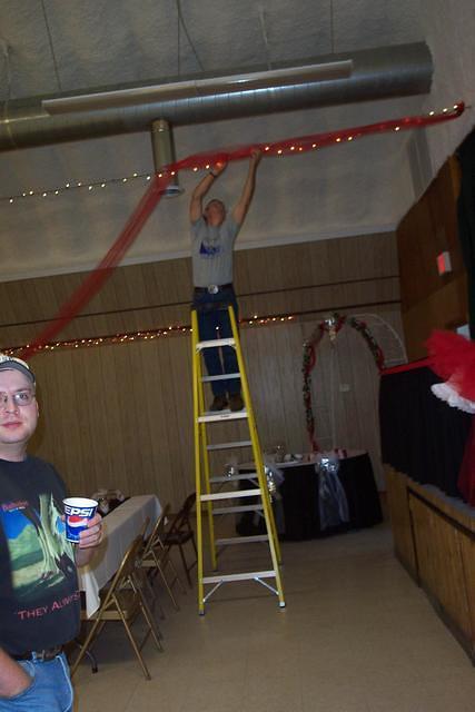 Richard, hanging up decorations. 10/3/03