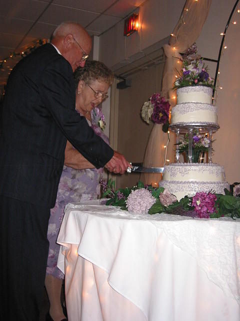 Gram and Pap cutting the cake.