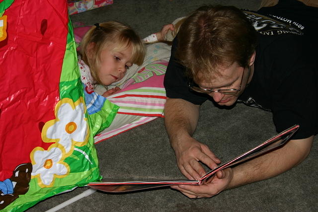 Uncle Shawn reads Carrie a bedtime story.
