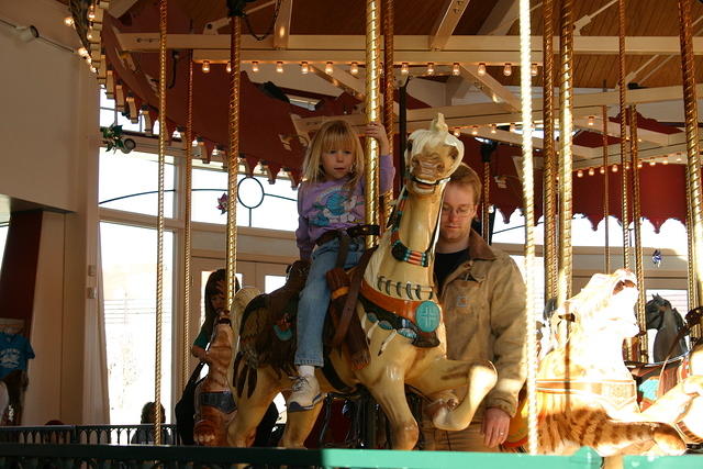 Shawn takes a turn on the carousel with Carrie.