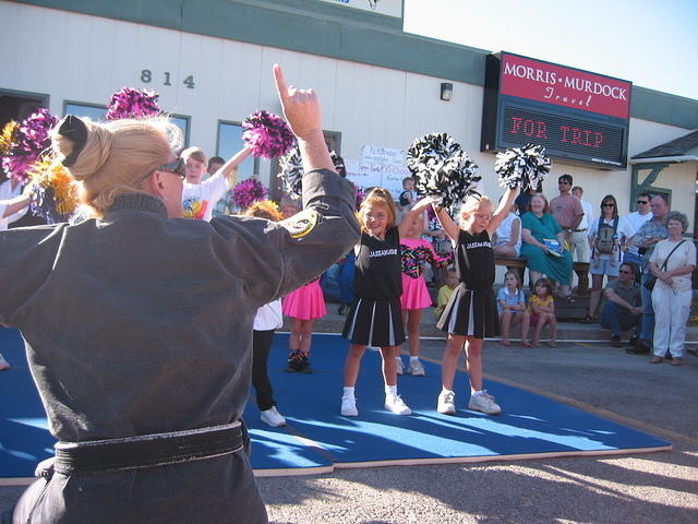 Miss Mary, helping all the girls out with their cheer.  Carrie's on the right, of course.