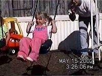 Shawn pushing Carrie on the swing - 5/15/02