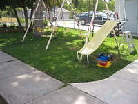 Part of Mom's yard, and Carrie's swingset. 8/24/03