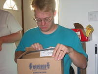 Shawn tried to open the box carefully to not get scratched. 10/5/03