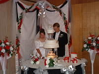 Michelle and Shawn cutting the wedding cake.