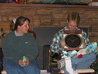 Michelle and Shawn, opening a clock, in hopes Shawn will make it to work on time. ;) - 9/12/03