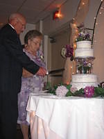 Gram and Pap cutting the cake.