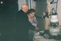 Gram and Pap cutting the cake