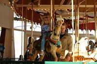 Shawn takes a turn on the carousel with Carrie.