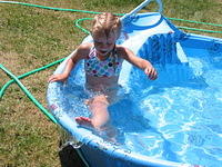 Carrie going down the slide in her pool.