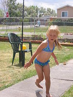 Carrie running from the sprinkler.