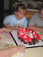 Carrie blowing out candles.
