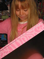 Carrie opening a strawberry shortcake metal case with art supplies inside.