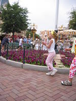 Carrie dancing around a circle with Alice in Wonderland on Main Street