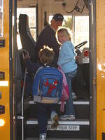 Carrie getting on her school bus.