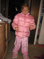 Carrie, dressed up in her pj's and her winter coat to go to pj night at church, and pretending to pout.