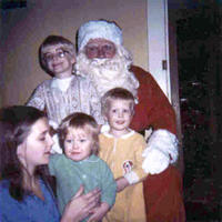 Ric, Shawn, Mom, and Paige with Santa.  I had to be held in front 'cause I wouldn't go near him.